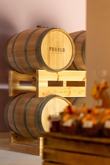 A wooden wine rack with multiple barrels labeled 'FUGOLO'. 1