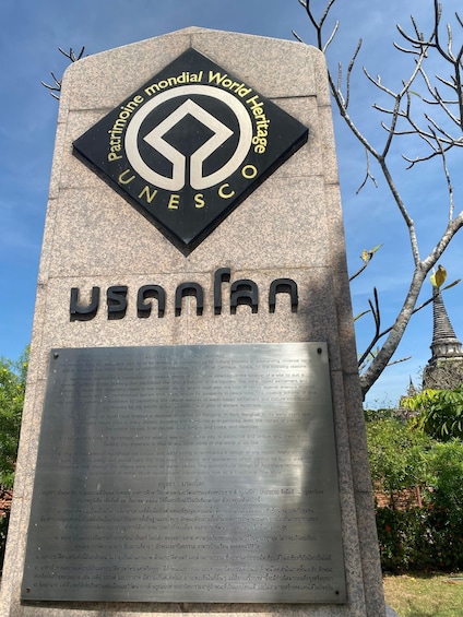 A UNESCO World Heritage sign with a detailed plaque below it. 4