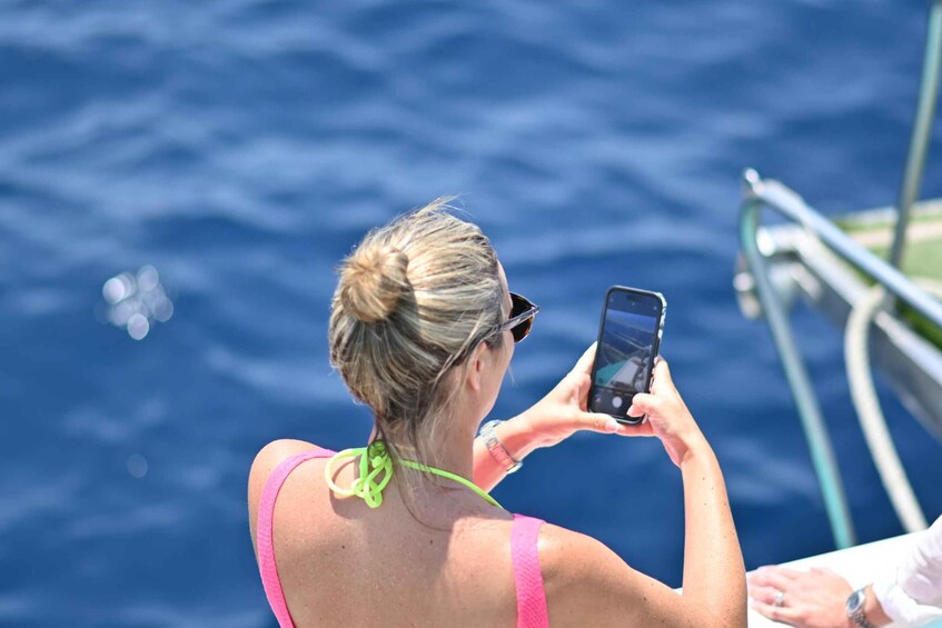 A person taking a photo with a smartphone. 3