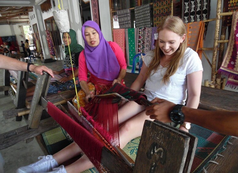 People weaving textiles on traditional looms. 1