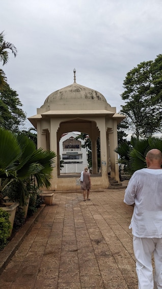 A domed structure with a sign reading "Cape Town Fish Market" in the background. 2