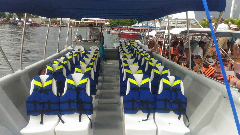 A boat with rows of blue and yellow life jackets. 5