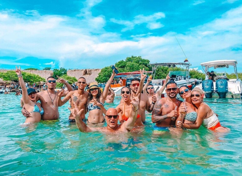 A group of people in a swimming pool with boats in the background. 1