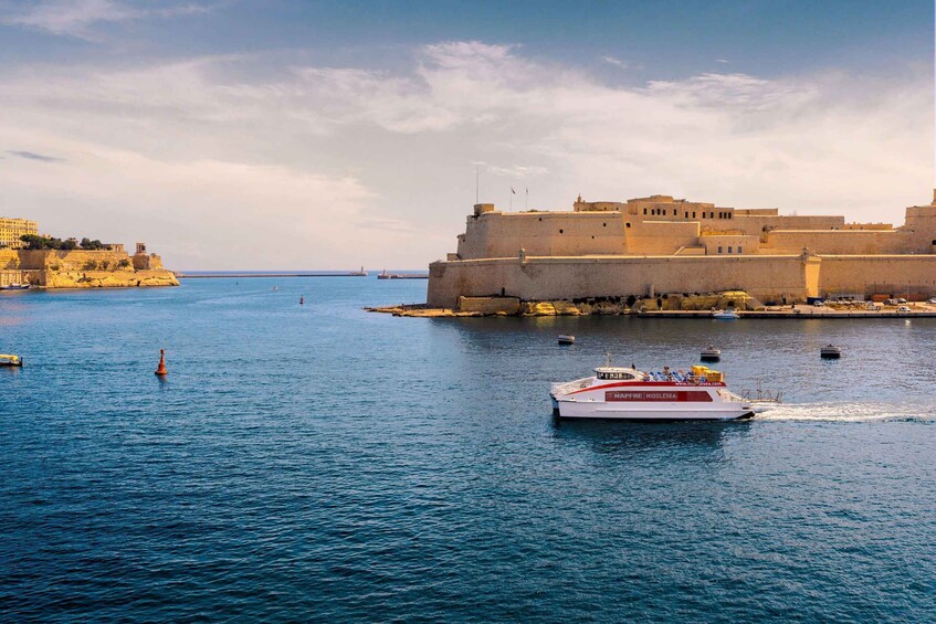 A harbor with a large fort and a ferry boat named "MARINE MIDDLESEA" in the foreground. 3