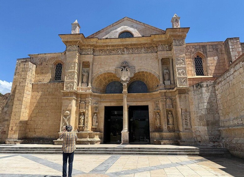 A historic building with intricate carvings and a central entrance. 1