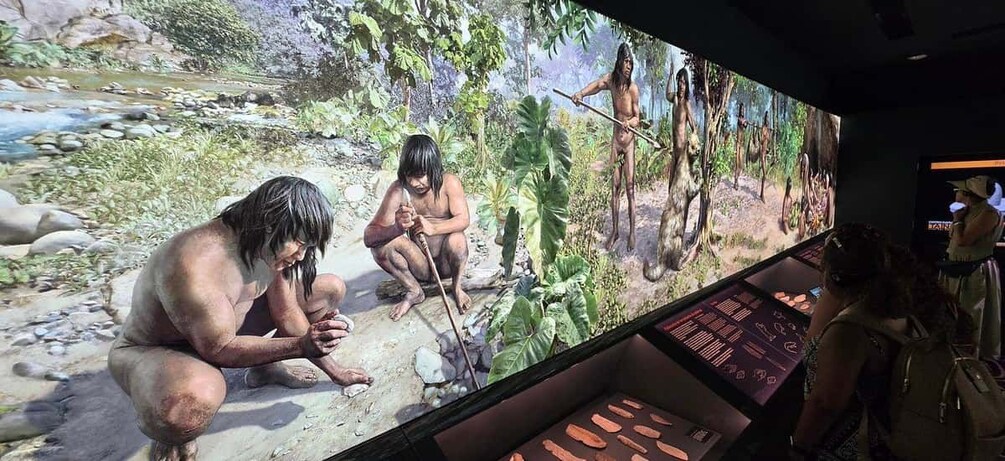 A large interactive display with prehistoric figures and a river scene. 5