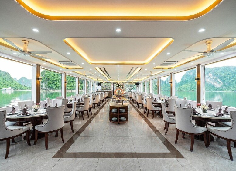 A dining area with tables and chairs, large windows, and a view of a lake. 3
