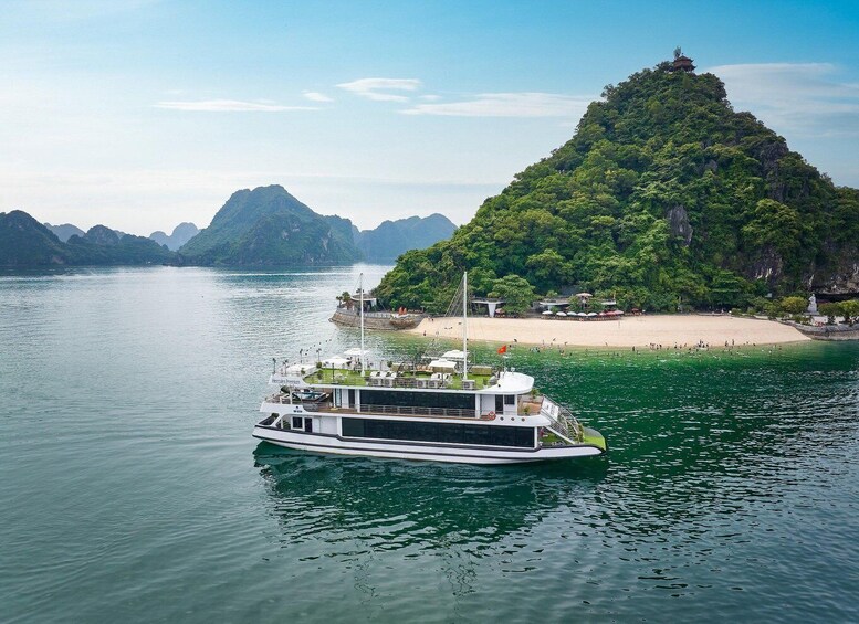 A boat named 'Hercules Princess' on a calm river, surrounded by lush green hills and a sandy beach with a temple on a hill. 1