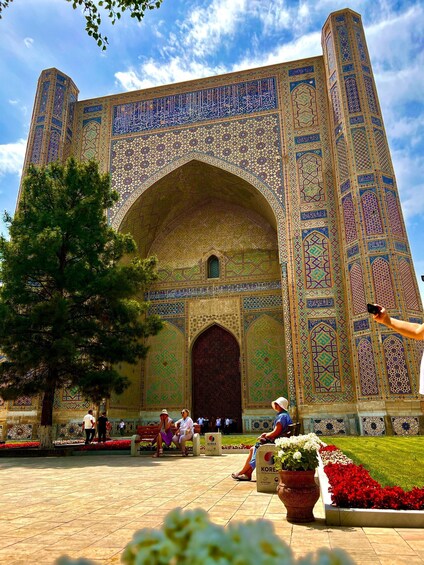 A large, intricately designed building with a prominent archway and detailed tile work. 4