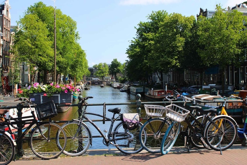 A canal with boats, bicycles, and buildings along the water. 5