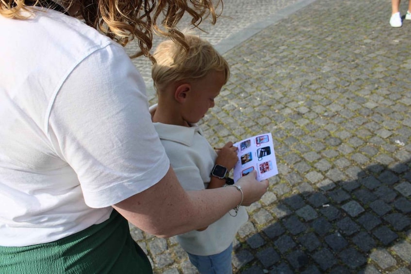 A person holding a booklet with pictures. 2