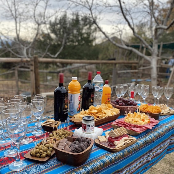 A picnic setup with various food items and drinks on a table. 3