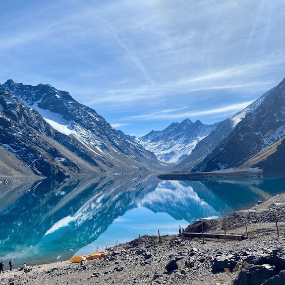 A mountain lake with clear reflections, rocky shores, and snow-capped peaks. 4