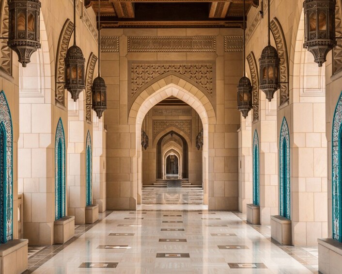 A grand hallway with ornate arches and patterned tiles. 2