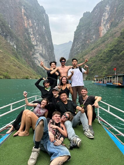 A group of people on a boat in a canyon with steep cliffs. 1