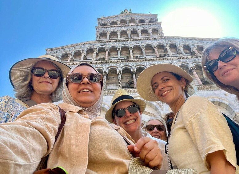 A group of people taking a selfie in front of the Colosseum in Rome. 5