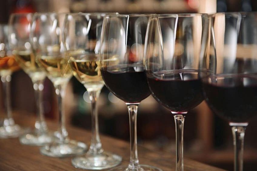A row of wine glasses on a wooden surface. 2