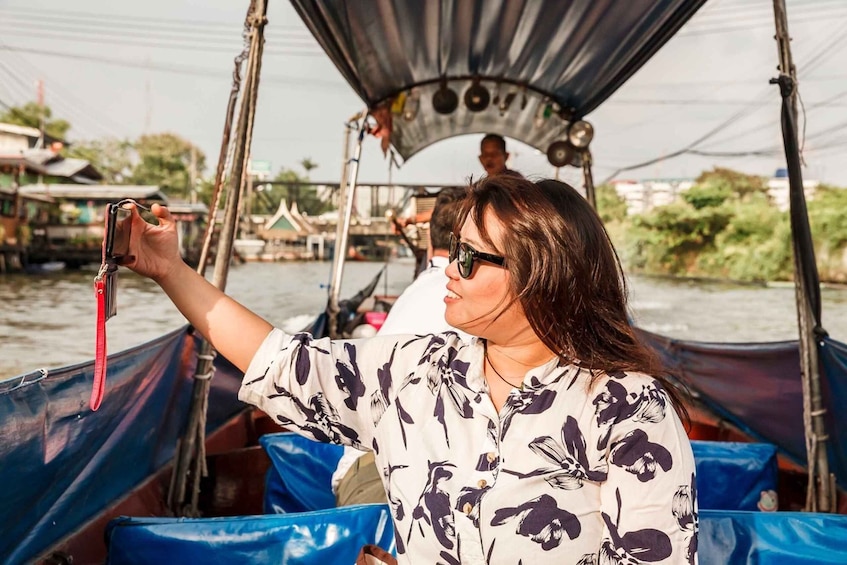 A person taking a photo on a boat. 5