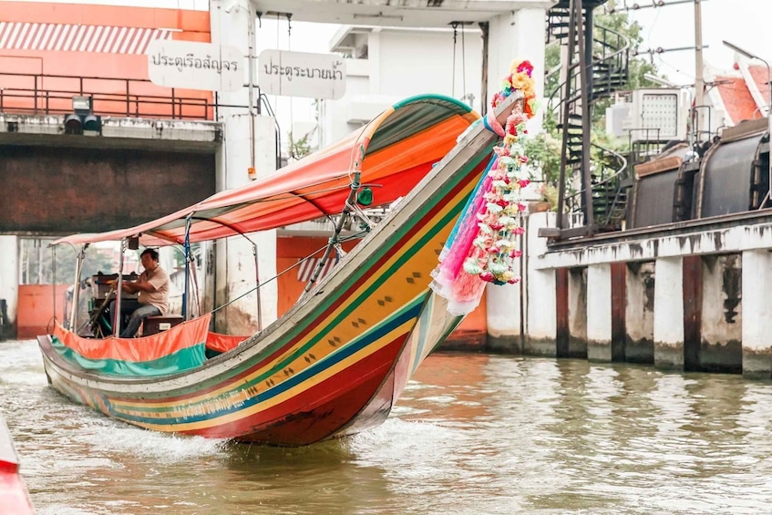 A colorful boat with a floral decoration, floating on water. 3