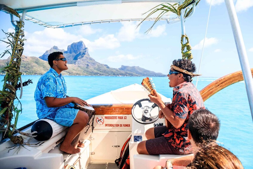 Two people on a boat with a mountainous landscape in the background. 4