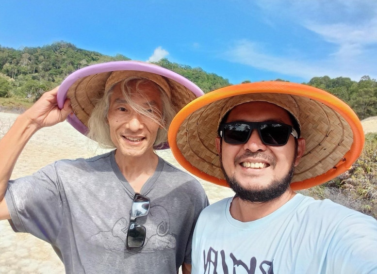 Two people on a beach with hats and sunglasses, and a clear sky. 2