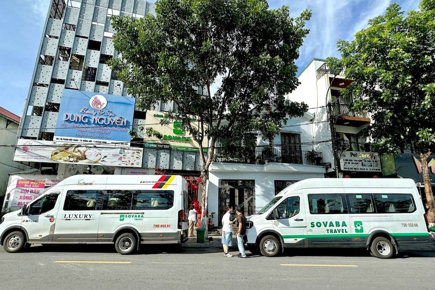 Two white vans parked on a street, one with 'LUXURY' and the other with 'SOVABA TRAVEL' branding. 5