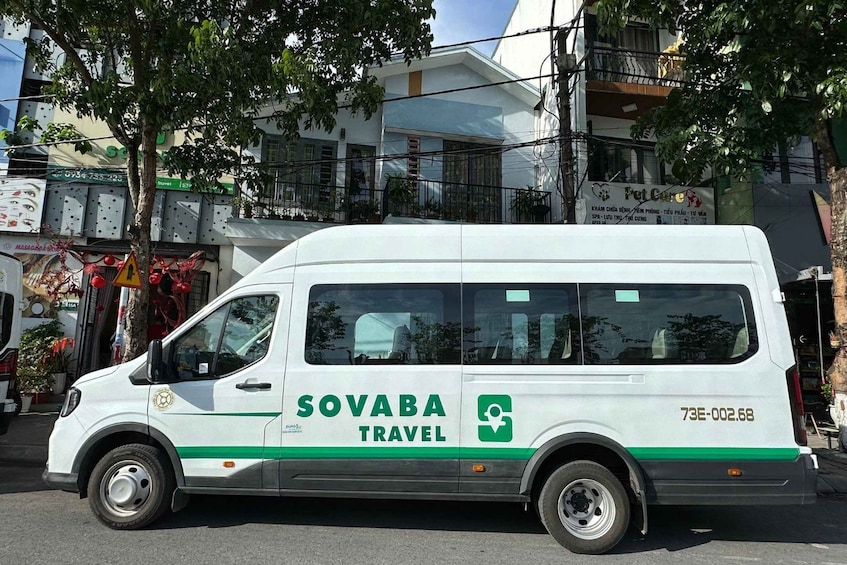 A white van with green stripes and the text 'SOVABA TRAVEL' parked on a street. 2