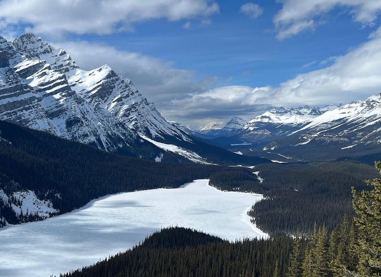A snow-covered mountain range with a frozen lake in the valley. 2