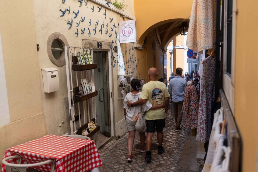A narrow street with a shop displaying handmade jewelry. 3