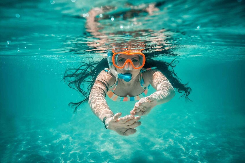A person swimming underwater. 1