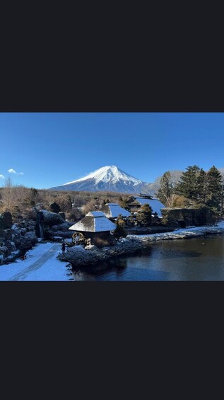 A snow-covered landscape with a mountain, buildings, and a river. 4
