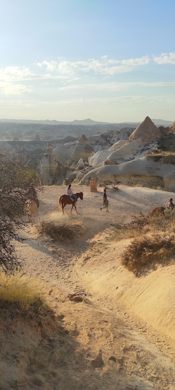 A desert landscape with rolling hills and a clear sky. 5