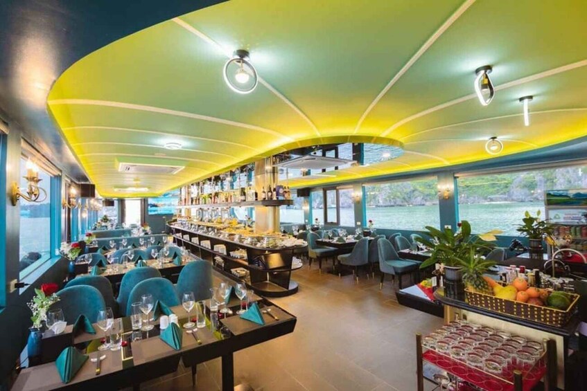 A restaurant with a curved ceiling, tables with chairs, a bar area, and a view of the water outside. 3