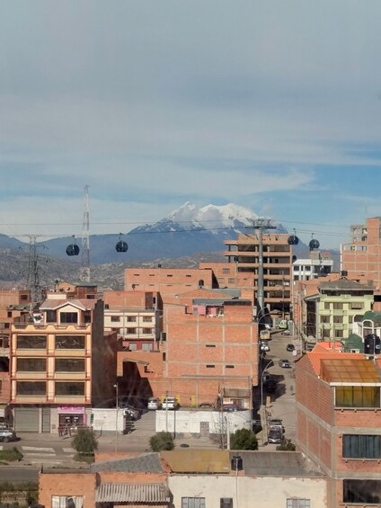A cityscape with buildings and a mountain in the background. 5