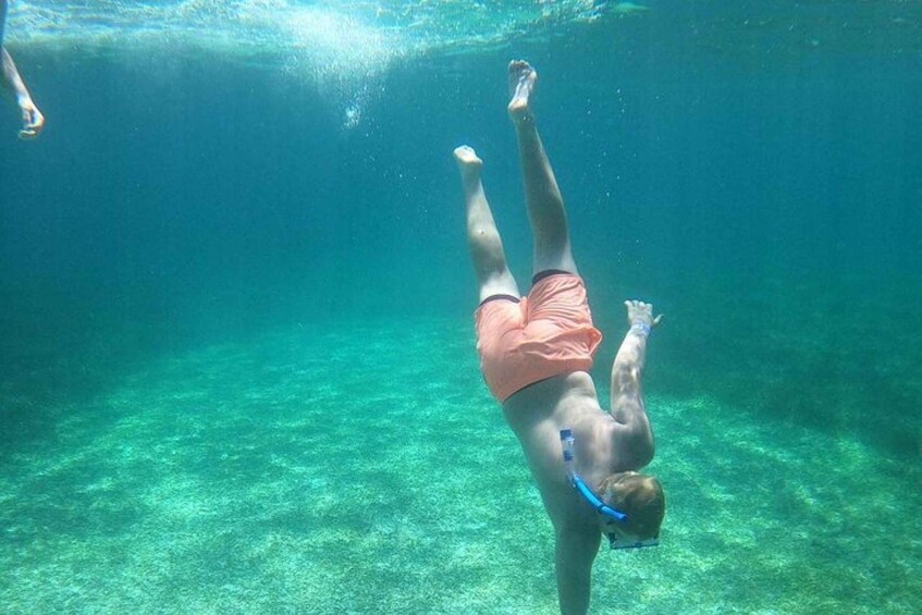 A person swimming underwater. 5