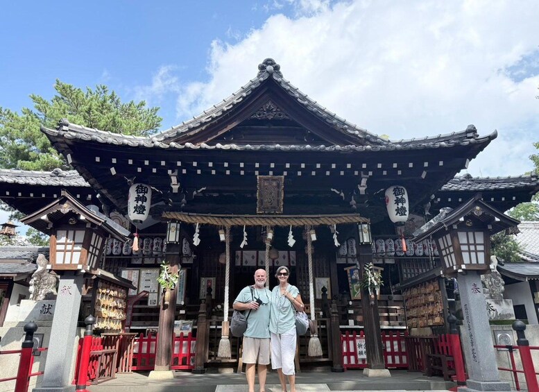 A traditional Japanese temple with a tiled roof and wooden structures. 5