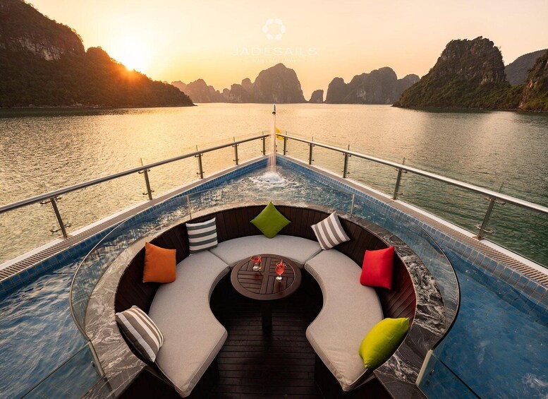 A boat deck with a hot tub, seating area, and a view of the water and mountains. 5