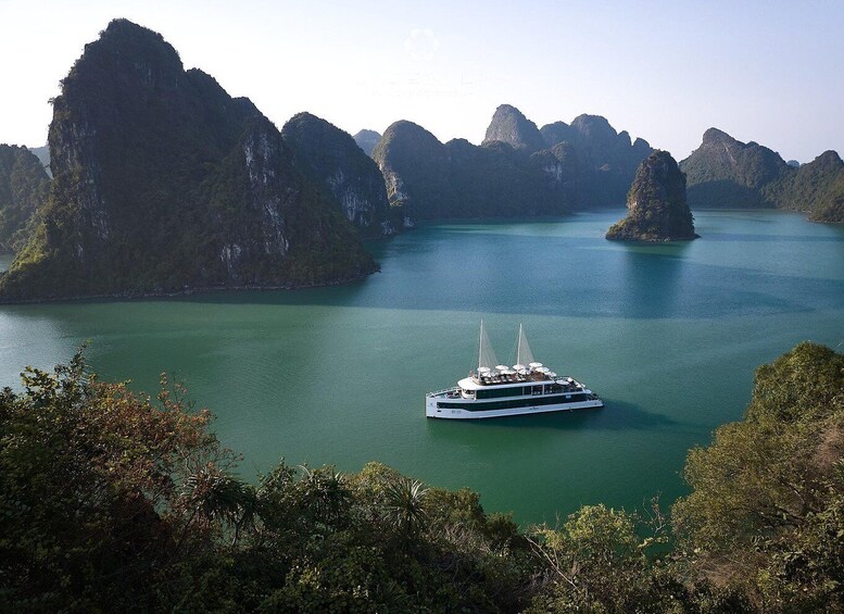 A boat on a calm river surrounded by limestone karsts. 1