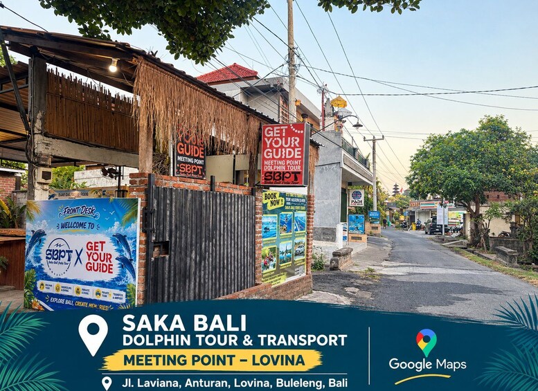 A street in Bali with a sign for a dolphin tour and transport meeting point. 2