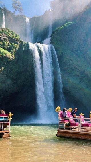 A waterfall with a boat in the foreground. 3