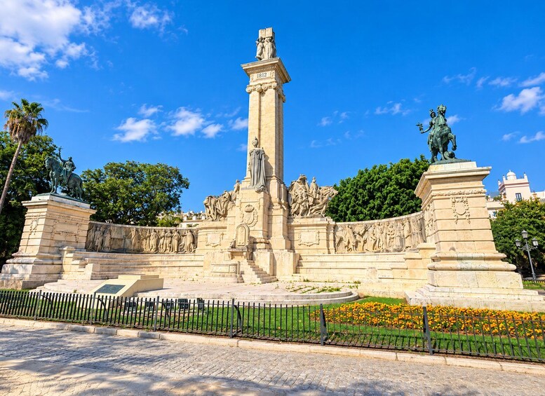A large monument with a tall central column, surrounded by intricate bas-relief sculptures and statues. 5
