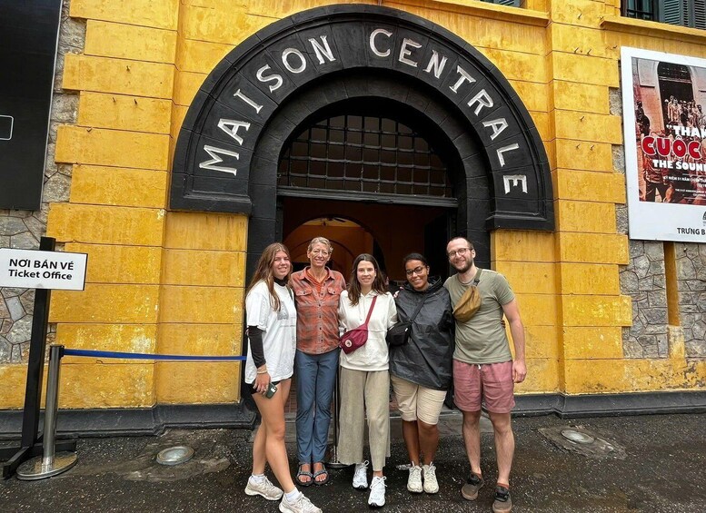 A group of people standing in front of Maison Centrale. 3