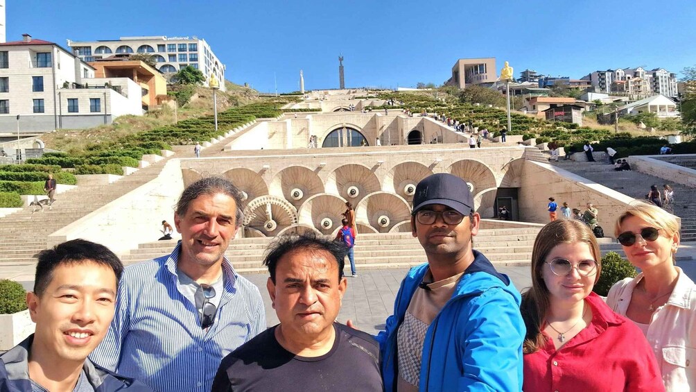 A group of people standing in front of a large staircase with a statue in the background. 5