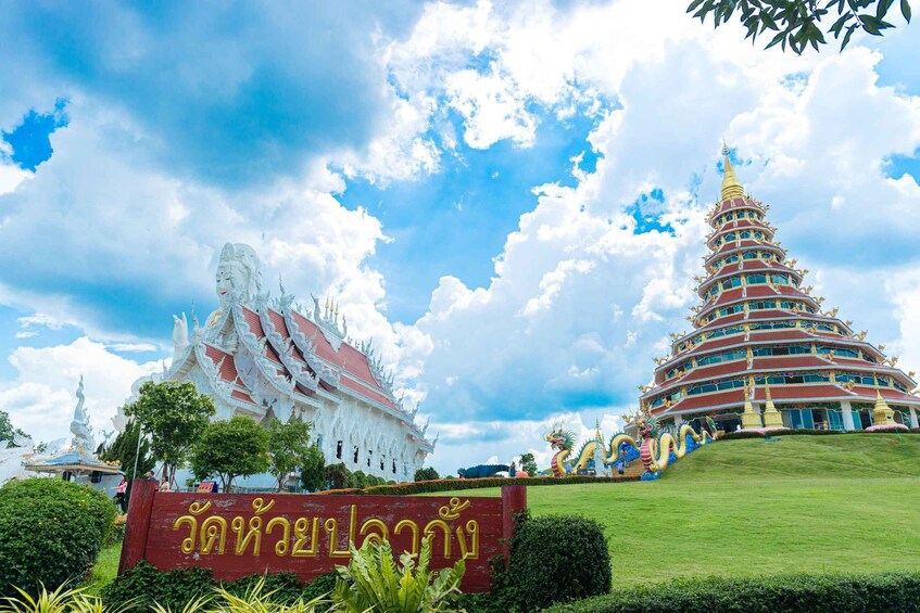 A large white temple and a multi-tiered pagoda with golden decorations. 5