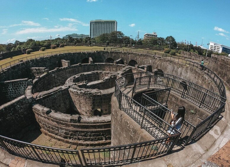 An ancient stone structure with circular walls and a spiral staircase. 1