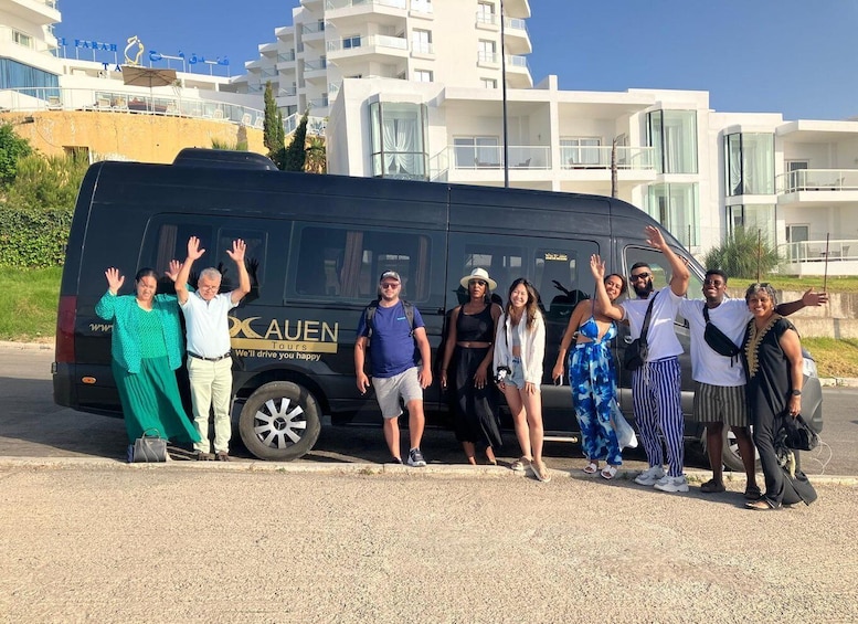 A group of people standing in front of a black van with 'CAUEN Tours' written on it. 3
