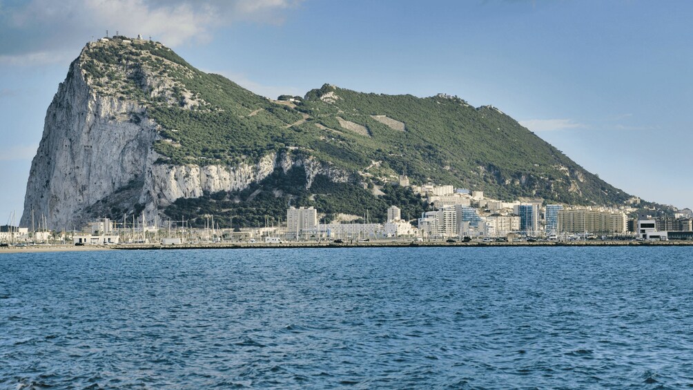 A coastal city with a prominent mountain and a marina. 2