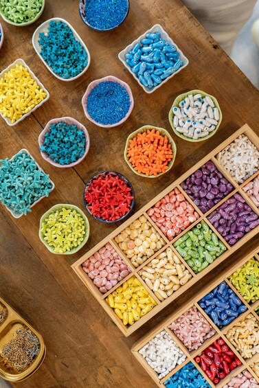 A variety of colorful beads and crystals organized in bowls and wooden trays. 5