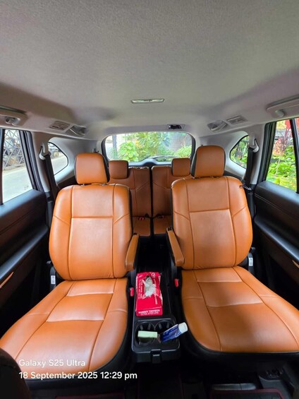 The interior of a Galaxy S25 Ultra car with brown leather seats and a center console. 3
