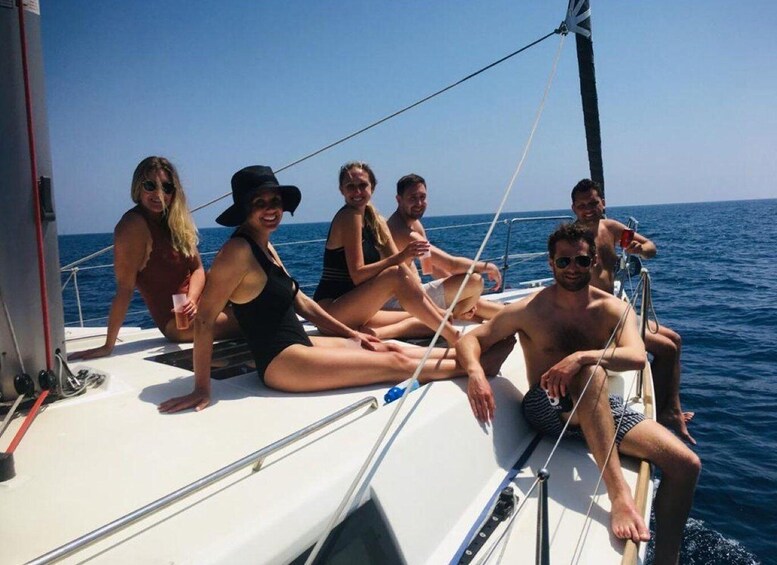 A group of people on a sailboat in the ocean. 1
